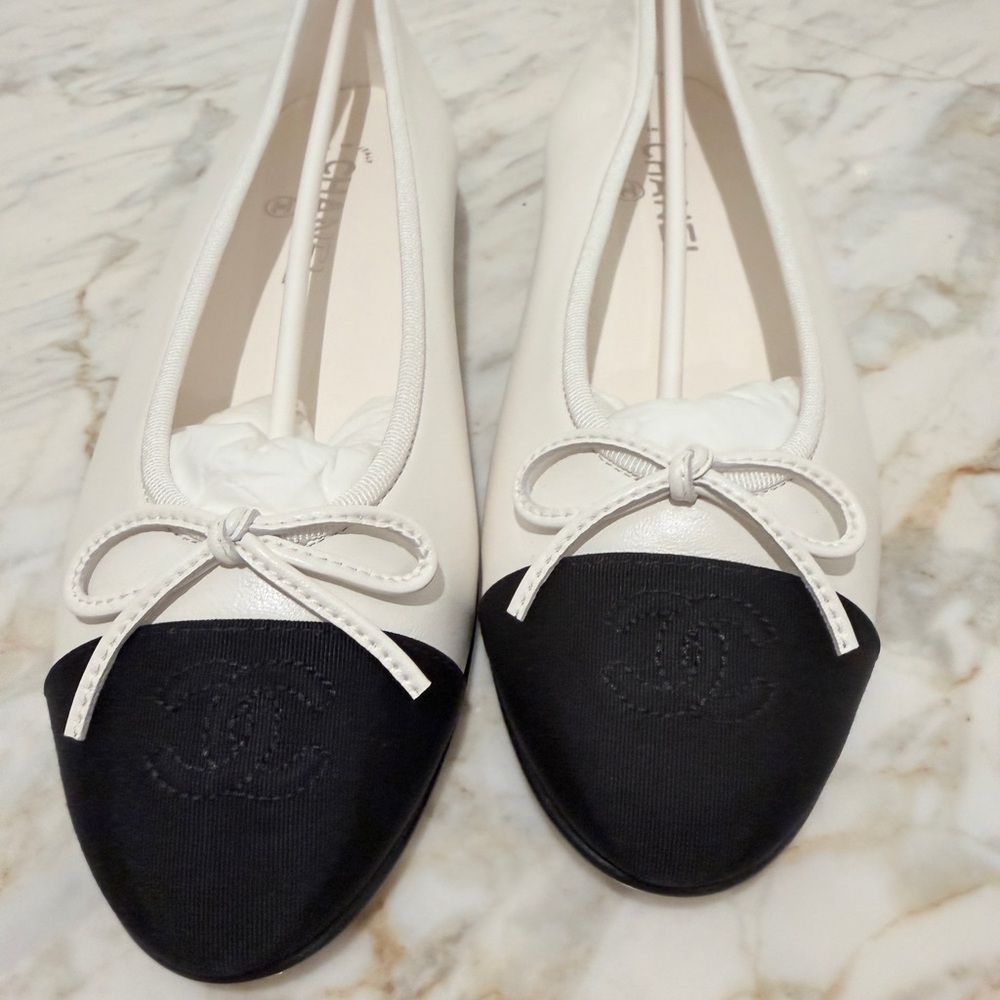 CHANEL White Leather Ballet Flats with Black Cap Toe and Bow